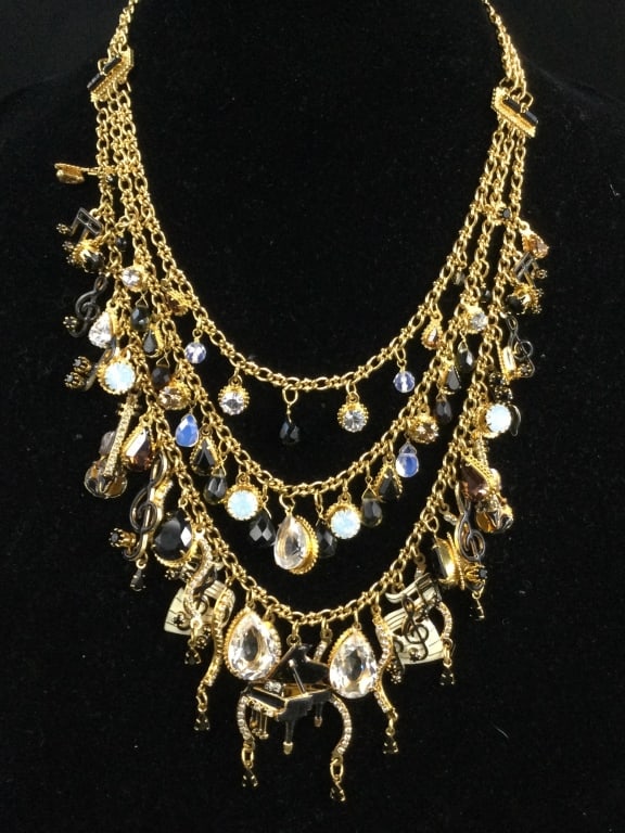 Lunch at the Ritz Musical Necklace: Nice triple strand necklace with musical notes and piano in center. Condition is good, see pictures. No refunds given.