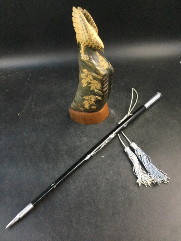 Vintage Lot: In this lot is a carved ox horn bird. Measures 11 1//4"h x 3"w. The other piece is a swagger stick and measures 21". Condition is consistent with age and use, see pictures. No refunds given.
