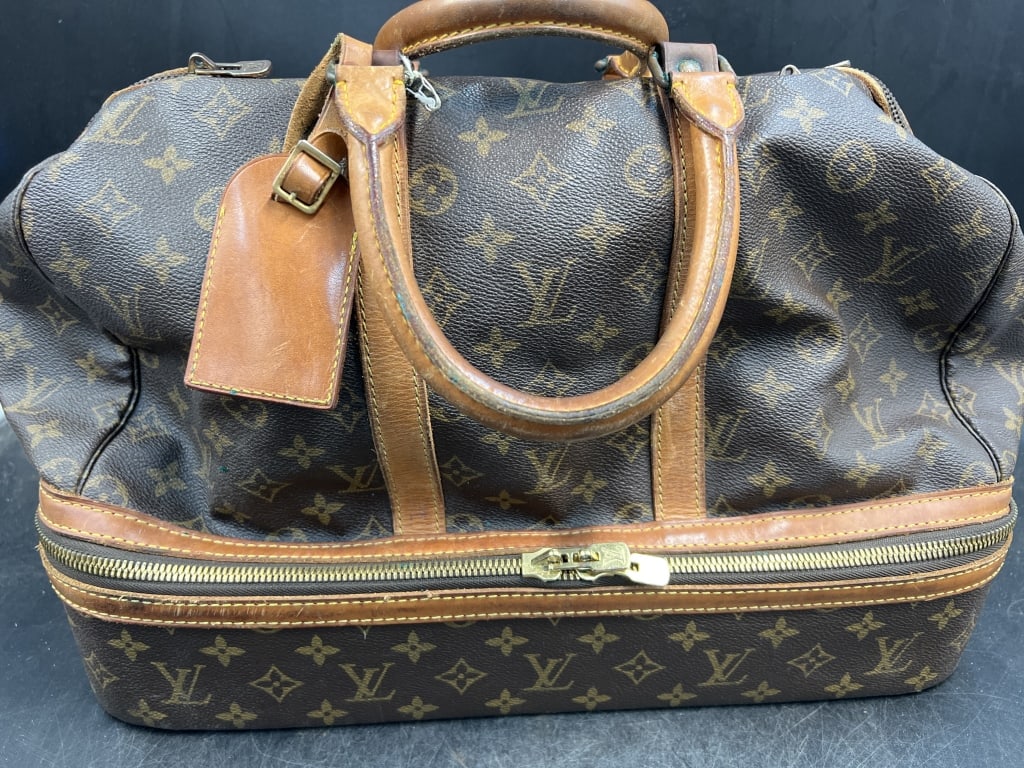 Louis Vuitton Travel Bag: Large bag for traveling with bottom compartment. Condition is consistent with use and age, see pictures. Bag was in storage needs some cleaning. No refunds given.
