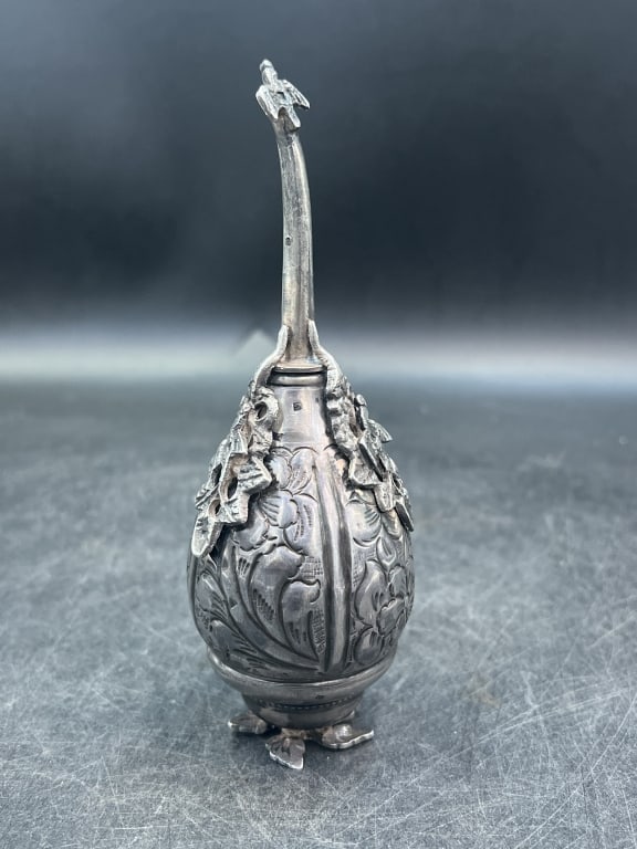 Egyptian Silver Bottle Rosewater Shaker: Measures 6.5" h and condition is consistent on age and use, see pictures. Antique 900 silver with engraved floral patterns and foliate base. Weighs 126.3g. Spout is detachable and features cast bird. 