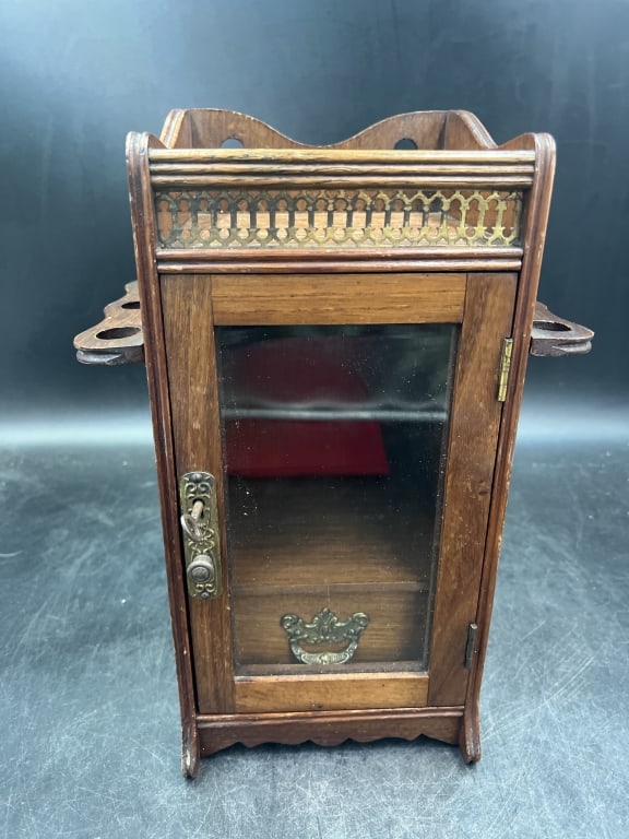 Antique Gentlemen's Pipe and Tobacco Cabinet: Nice cabinet made for storing pipes and tobacco. Nice grain finish and deetails that elevate this piece. Measures 12.5"h x 8.5". Front has glass door with skeleton key hole with key. Also pull. Inside
