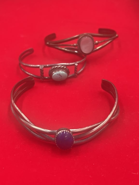 Sterling Cuff Bracelets: Total of 3 in this lot. They all have a gemstone such as lapis, mother of pearl and turquoise. Total weight of all is 42.0. Bracelets measures inside 4", 4 3/4" and 5". See pictures, no refunds given.