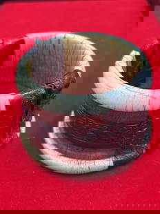 Early Cuff Ivory and Silver Bracelet: This bracelet is made with mammoth ivory and wrapped with hand hammered silver. Measures 2"w and cuff opens. There is a pin to pull to open. See pictures, very neat piece. No refunds given.
