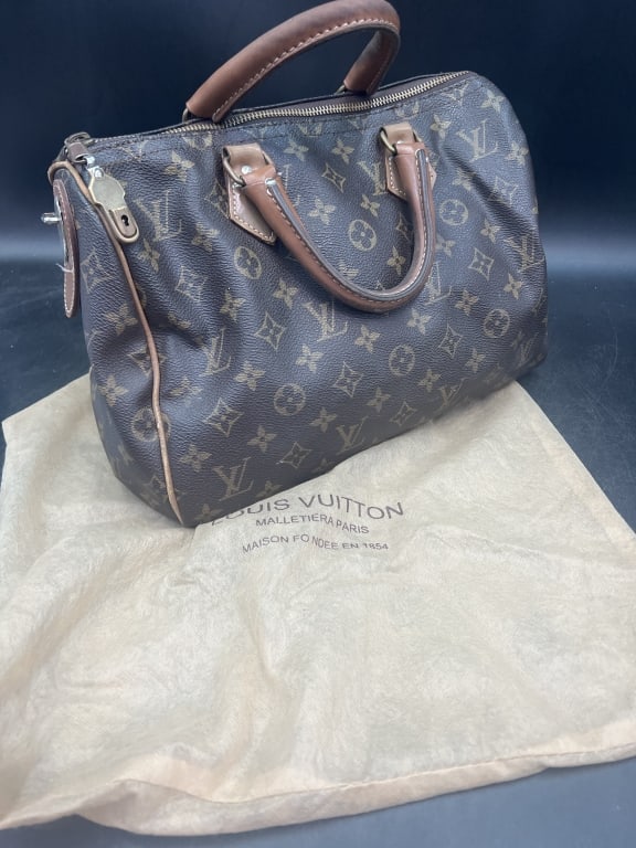 Vintage Louis Viutton Speedy Bag: Comes with dust cover. This bag was purchased in Germany back in the 50' when husband was in Army. Condition is consistent with age and use, see pictures. Some wear on handle from use. Has lock but no