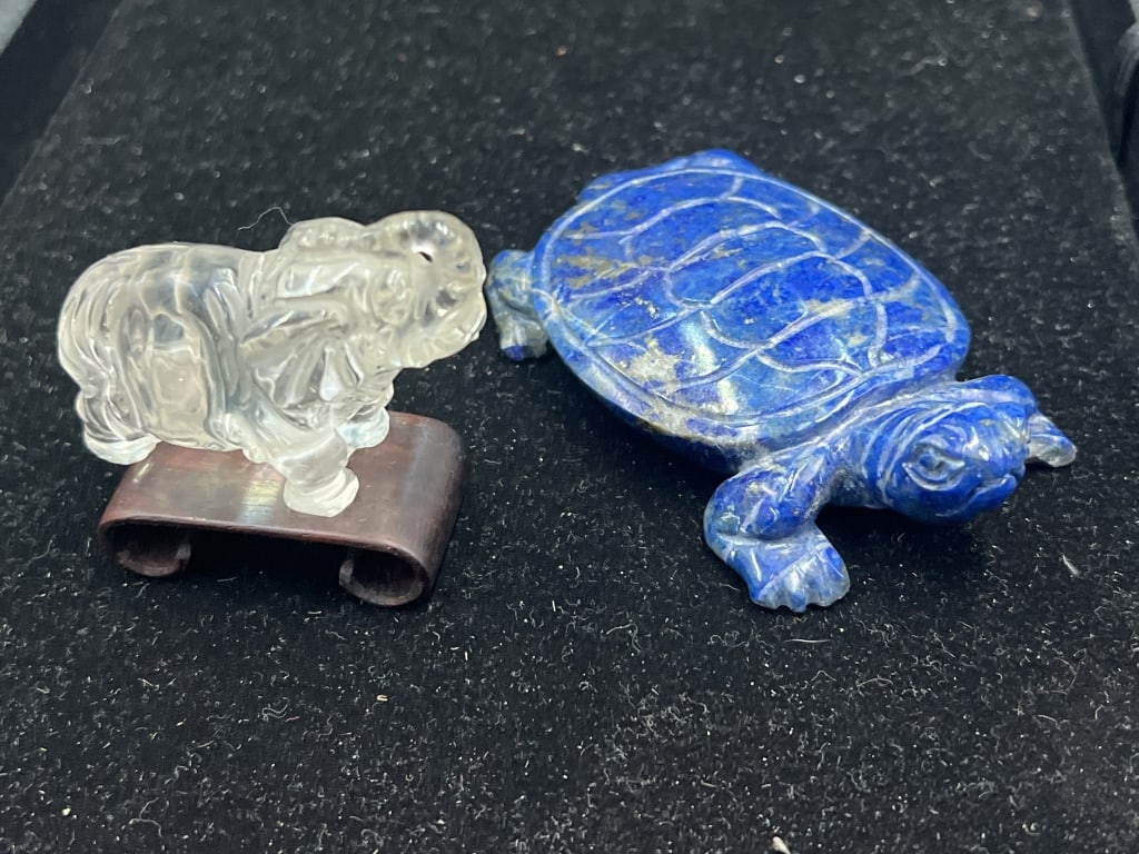 Carved Animals: In this lot there is a carved clear quartz elephant "signed" ( 2 3/4" x 1 1/4") with stand. There is also a lapis turtle 3 3/4" x 2 1/4". Condition is consistent with age and use, see pictures. No ref