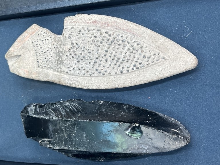 Vintage Native American Artifacts: One is a celt or axe head made out of stone (9"). The other piece is obsidian likely a tool or part of one (8"). Condition on both is consistent with age and use, see pictures.No refunds given.