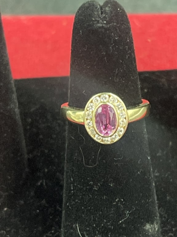 18kt Gold Ring with Oval Shaped Sapphire: Nice ring with a Padparadscha sapphire with a diamond halo. Condition is good, no pictures. Ring is a size 6.5 and weighs 5.0g. No refunds givenCondition Information: It is the responsibility
