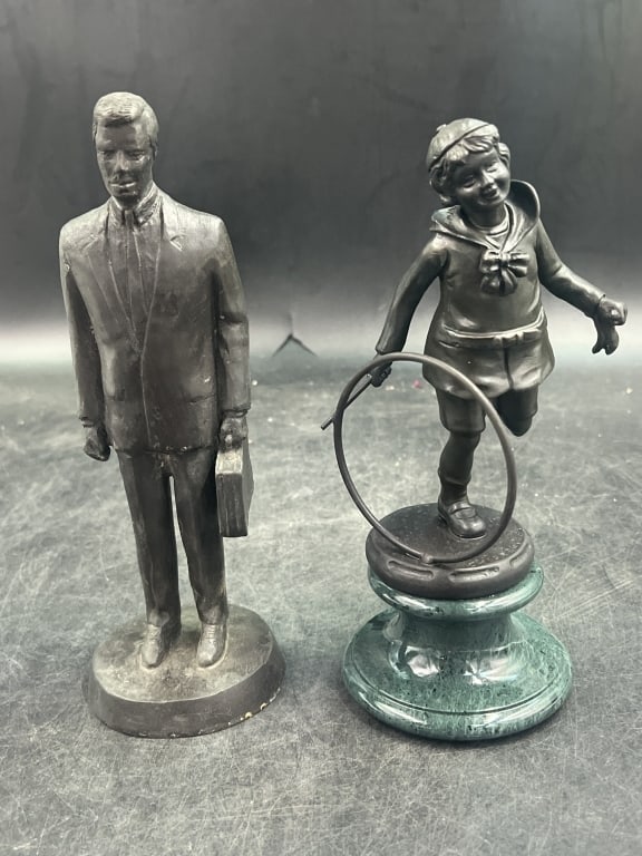 Bronze Statues: Total of 2 in this lot. There is a man with briefcase and girl with hula hoop. Condition appears to be good, see pictures. Measures 8.5" and 9". No refunds given.Condition Information: It is