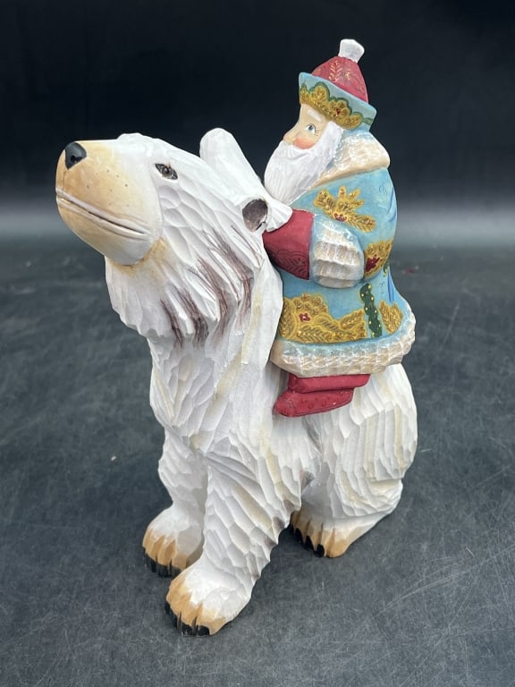 Russian Santa Claus Hand Carved: Russian carving of Santa Claus riding a polar bear. Hand carved from solid linden and sanded and hand painted. Measures 9" and has original Made in Russia tag on bottom. Condition is