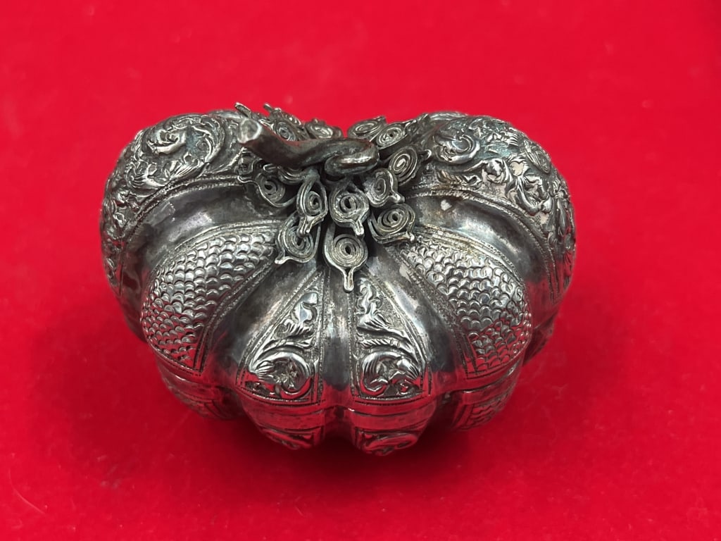 Vintage Southeast Asian Repousse Silver Bezel Nut: Box typically shaped like a pumpkin or squash. Dated to late 19th to early 20th century Malaysia. Intricate hand chased floral scroll or scale decoration. Measures 2 1/4"x 2.5" x 2". 