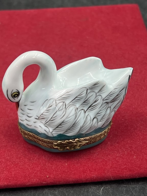 Limoge Trinket Box 'Rochard': Shaped like a swan on the lake. Hand painted porcelain and hinged design. Signed Limoges. Condition is good, see pictures. No refunds given.Condition Information: It is the responsibility of