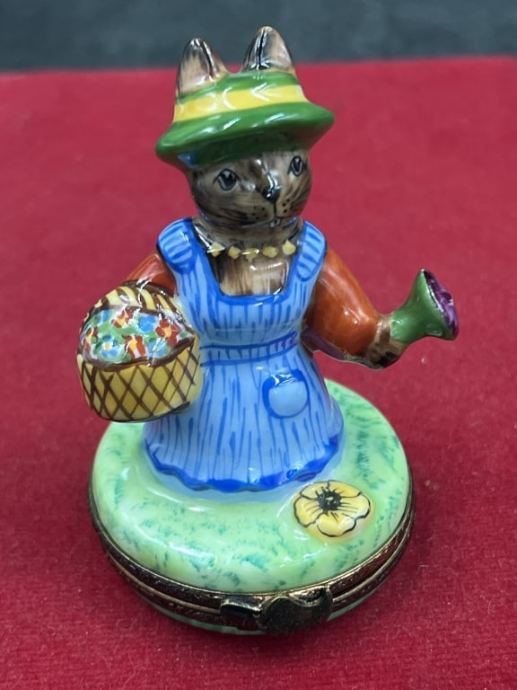 Limoge Trinket Box LE #076/750: Featuring hand painted rabbit gardener. Limoge porcelain signed. Figurine depicts a rabbit wearing a green hat and blue dress, holding a basket of flowers. Limited edition and signed by