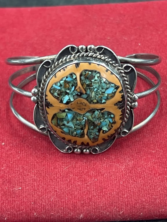 Vintage Navajo Bracelet: Features turquoise inlay set within walnut shell. Surrounded by sterling silver rope and decorative work. Intricate chip inlay design and heavy silver wire bands. Weighs 27.1g and measures 1 3/4" x 5