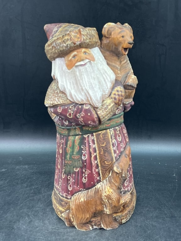 Hand Carved Russian Santa Claus 'Ded Moroz': Features traditional Old World artistry and signed by artist on bottom. Depicts Santa with Bears, featuring intricate red and gold detailing on his coat. Crafted from linden wood. Measures 14"