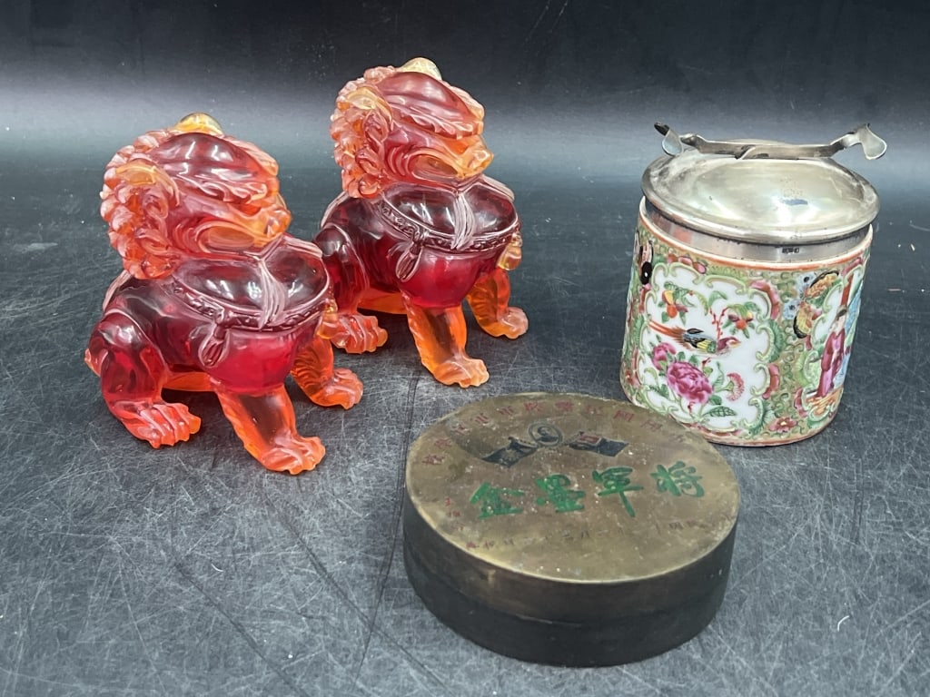 vintage Mix Lot: Lot includes a pair of red amber Chinese Food Dog figurines (Measures about 4"). There is also a antique Chinese lidded box with floral patterns (4") that lid has prongs and see marker marks for silve