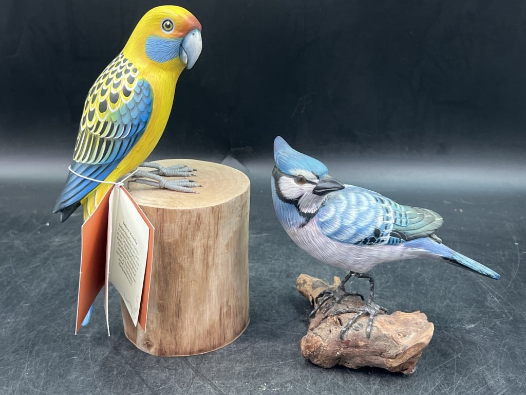 Hand Painted Wooden Sculptures: One is a Yellow Rosella Bird (8.5"). Sitting on a stump with bright yellow body, blue checks and should patches. Carved from Suar Wood. The other is a Blue jay figurine (5.5"). Condition is