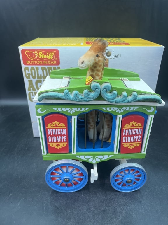 Steiff 'Gold Age of the Circus': African Giraffe plush animal housed inside decorative wooden cage wagon. Steiff Button in ear tag. Part of the Gold Age of the Circus 1980's. Original in box, see pictures. No refunds
