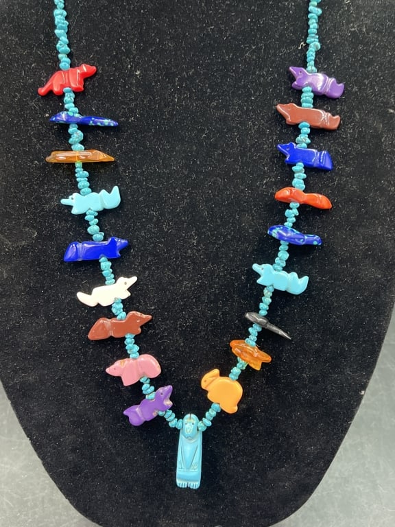 Native American Zuni Fetish Necklace: Features multiple hand carved stone animal figures with turquoise beads. Such as bears, rabbit, foxes, fish carved from lapis lazuli, coral etc. The centerpiece is larger carving representing a bear.