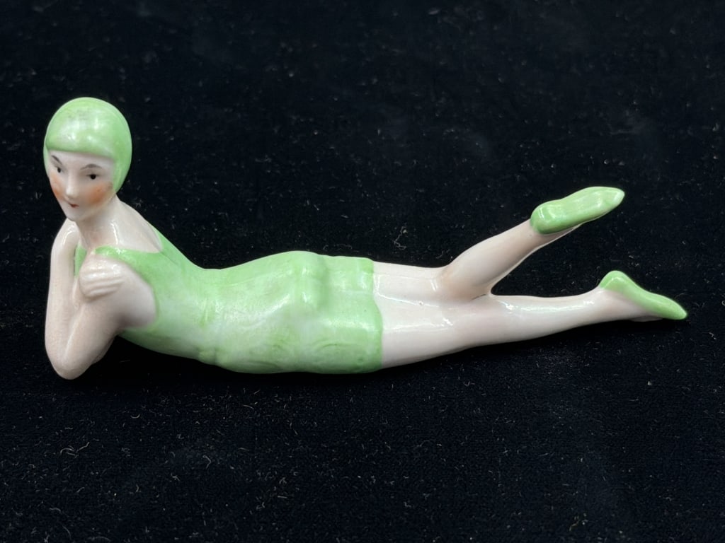 Antique Flapper Figure - Bisque Bathing Beauty: Art Deco 1920's Deco Flapper Green Bathing Suit. Measures 1 3 h x 4 1/4" l. Condition is good, no chips or cracks, no refunds given.
