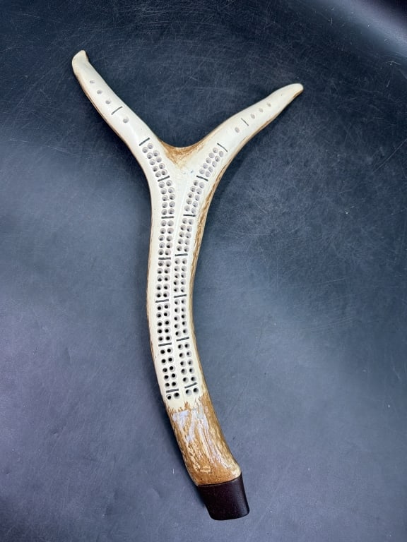 Cribbage Board: Hand made cribbage board from elk antler. Featuring a base capped with wood for peg storage. Measures about 16" x 9". Condition is consistent with age and use, see pictures. No refunds given.