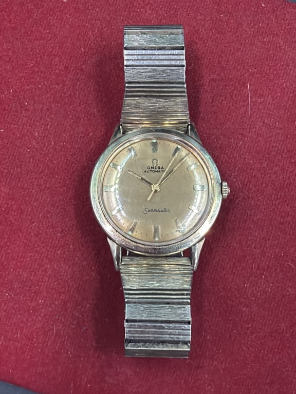 Vintage Omega Seamaster Watch: Class model introduced in 1948. Designed for versatility and suitable for both formal and causal settings. Featuring a stainless steel case and 14kt gold filled with distinctive textured metallic