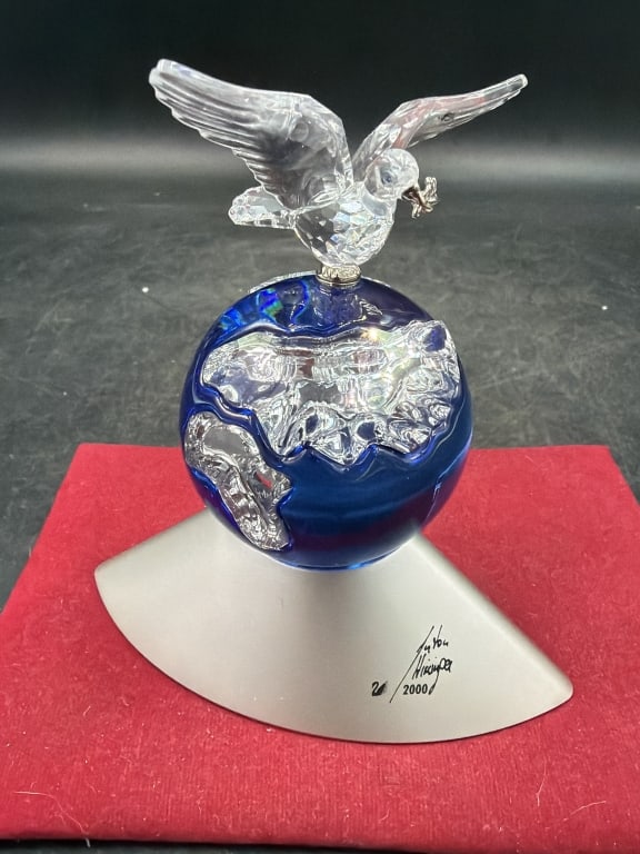 Swarvoski Crystal 'Crystal Planet': Figurine from the 2000 Millennium edition collection designed by Anton Hirzinger (signed). Consists of clear crystal eagle perched on top of a cobalt blue crystal globe with frosted silver
