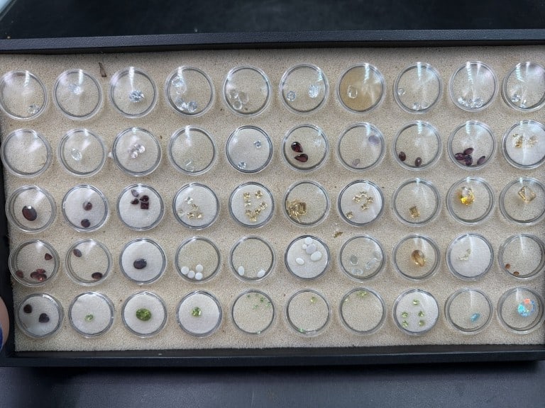 Gemstones: Huge lot of gemstones. Total of 50 circular gemstones holders. There is a variety of gemstones. See pictures. No refunds given.