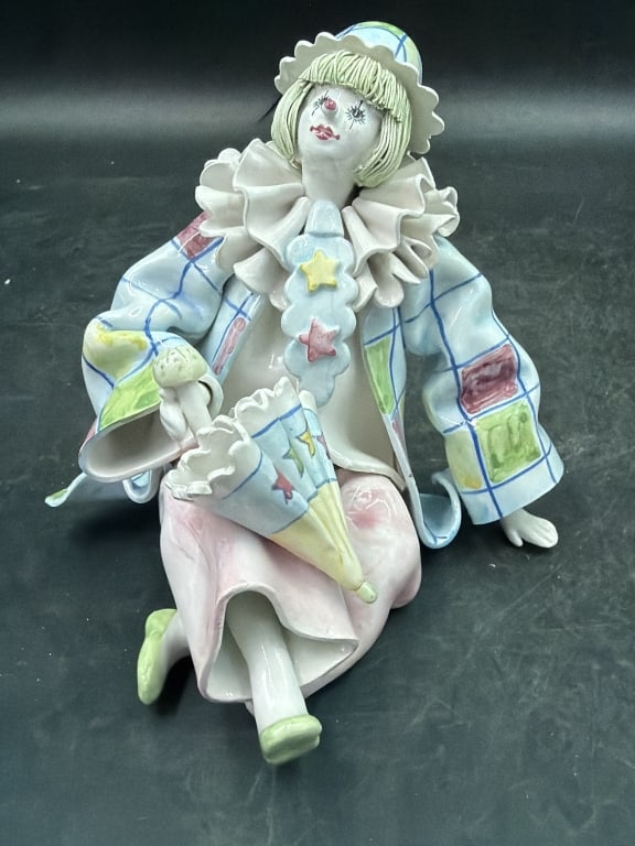 Vintage Pierrot or Jester Porcelain Figurine: Made in Italy seated clown and made from Gump's San Francisco. Porcelain with detailed features and delicate spaghetti hair. Pastel colors with intricate costumes. Marked Made in Italy. Condition