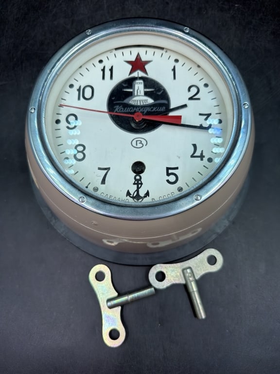 Vintage Soviet Era Vostok Submarine Clock: Heavy duty maritime clocks produced by Chisopol Clock and watch Factory. Features white dial with Arabic numerals, a red star at 12 o'clock and submarine log. Movement 13 jewel designed for 7 to 8
