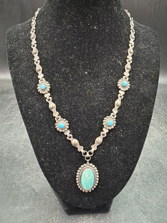 Navajo Sterling Necklace and Turquoise Pendant: Silver necklace featuring turquoise stones and prominent oval pendant, set in sterling silver. Weighs 25.8g and condition is good, see pictures. No refunds given.