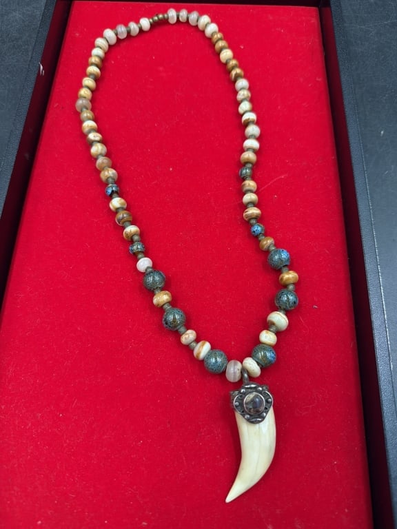 Tribal Necklace with Large Tooth Pendant: Strung with assorted gemstone beads, sterling and turquoise. A mix of earthy disc shaped bone spacers, smooth round gemstones (resembling hematite, jasper or tigers eye). Tooth capped with silver and