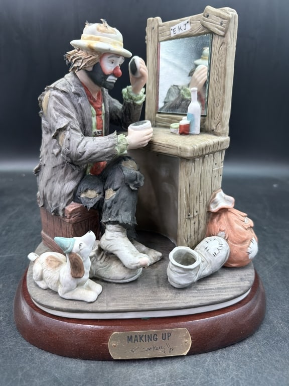 Emmet Kelly 'Making UP' LE #1063/7500: Features the famous hobo clown Weary Willie, applying his makeup in front of a vanity mirror. Measures around 10.5 " and condition is good. LE piece and comes with wood base. See pictures, no refunds