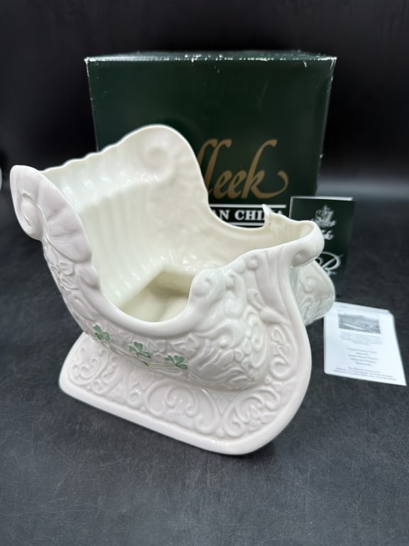 Belleek Fine Parian China: Comes with original box and has stamp on bottom. Sleigh shaped planter or centerpiece featuring shamrock accents. White porcelain with intricate embossed details such as swirling scroll. Measures abou