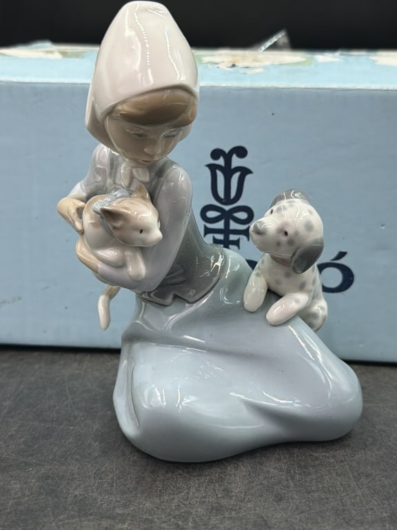 Lladro Figurine with Box 'Little Friskies': Comes with original box featuring a young girl holding a cat while accompanied by a small dog. Measures about 6.75" x 4.35". Issued 1979 and retired in 1998. Condition is good, see pictures. No