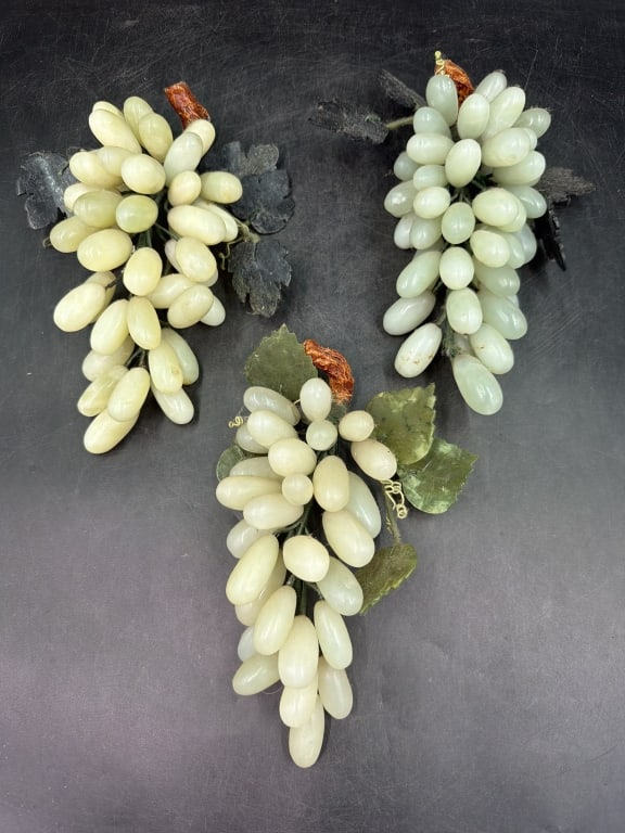 Vintage Jade Grape Clusters: Total of 3 vintage Chinese carved jade grape clusters. Mid century decorative accents features hand carved stone grapes and leaves bound together with bendable wire wrapped stems. Measures 9" to 10".