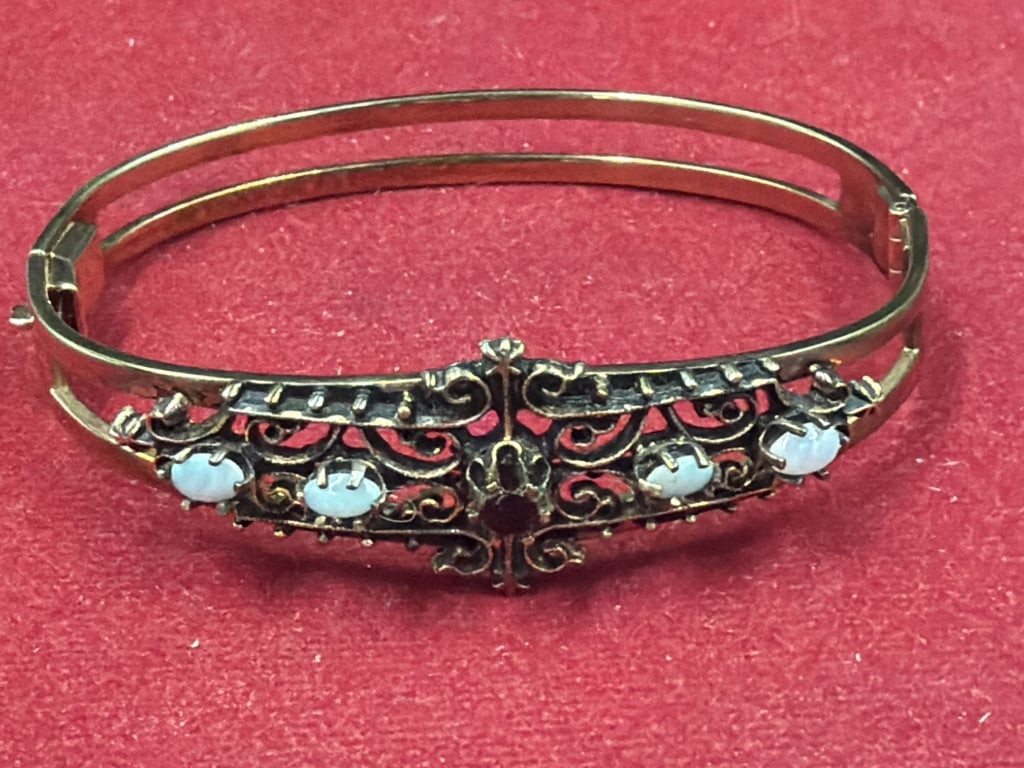 Vintage Victorian Revival Hinged Bangle Bracelet: Sterling silver bangle see mark. Featuring intricate scrolling old tone metal filigree design. Accented with clear faceted glass faux pearls alongside deep red glass gem. Weighs 23.3g and condition