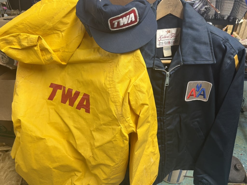Vintage Airline Jackets: This lot has a vintage yellow TWA rain jacket and hat. The other is AA jacket ground crew jacket. Condition is consistent with age and use. Sizes are about a small and medium. No refunds given.