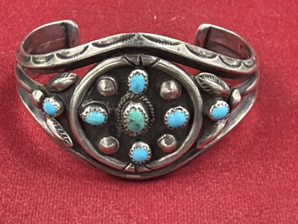 Navajo Cuff Bracelet w/Cluster Design 'Mary Lew': Central circular motif set with multiple turquoise stones accented by silver raindrops and hand stamped details on a split shank cuff. Signed piece "Mary Lew". Weighs 50.7g. See pictures, condiiton