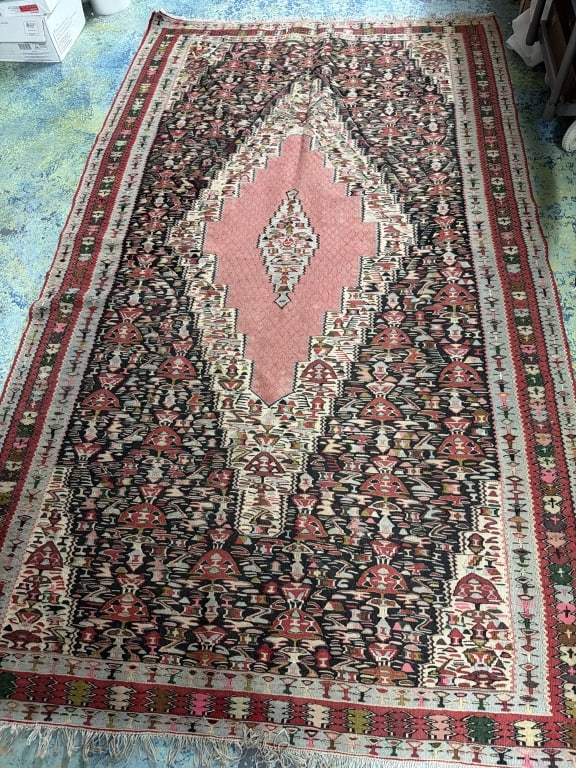 Vintage Persian Senneh Rug: Measures 98" x 59". Characterized by signature elongated, stepped central diamond medallion, pink coral field color and intricate geometric and floral filler motifs. Condition is consistent with age