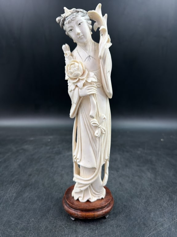 Antique Chinese Women Guanyin: Figure of lady holding a flower representing the deity Guanyin mounted on wooden base. Figure in long flowing detailed robes holding a floral spray. Measures 10". Condition is consistent with age and