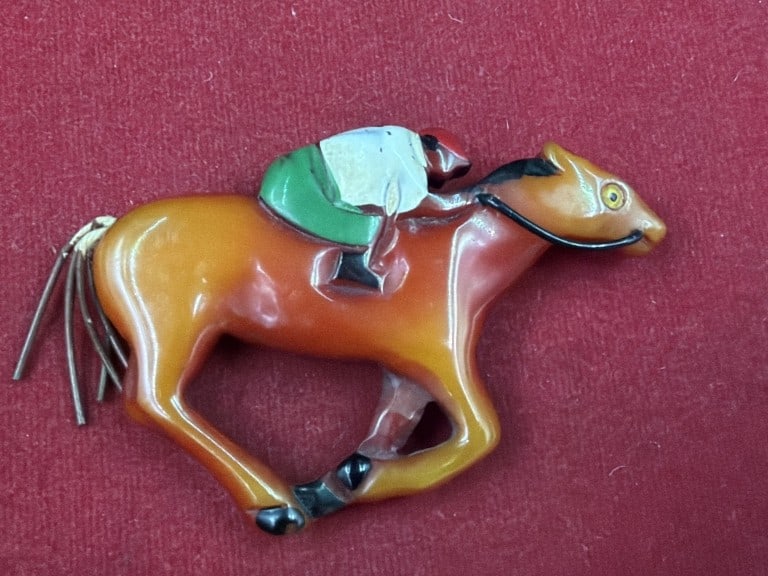 Vintage Mid Century Bakelite Figural Horse Brooch: Feature a stylized horse with a rider or equestrian elements. Distinctive burnt orange/butterscotch patina. Novelty brooch depicts a galloping or jumping horse. Condition is good, see pictures No