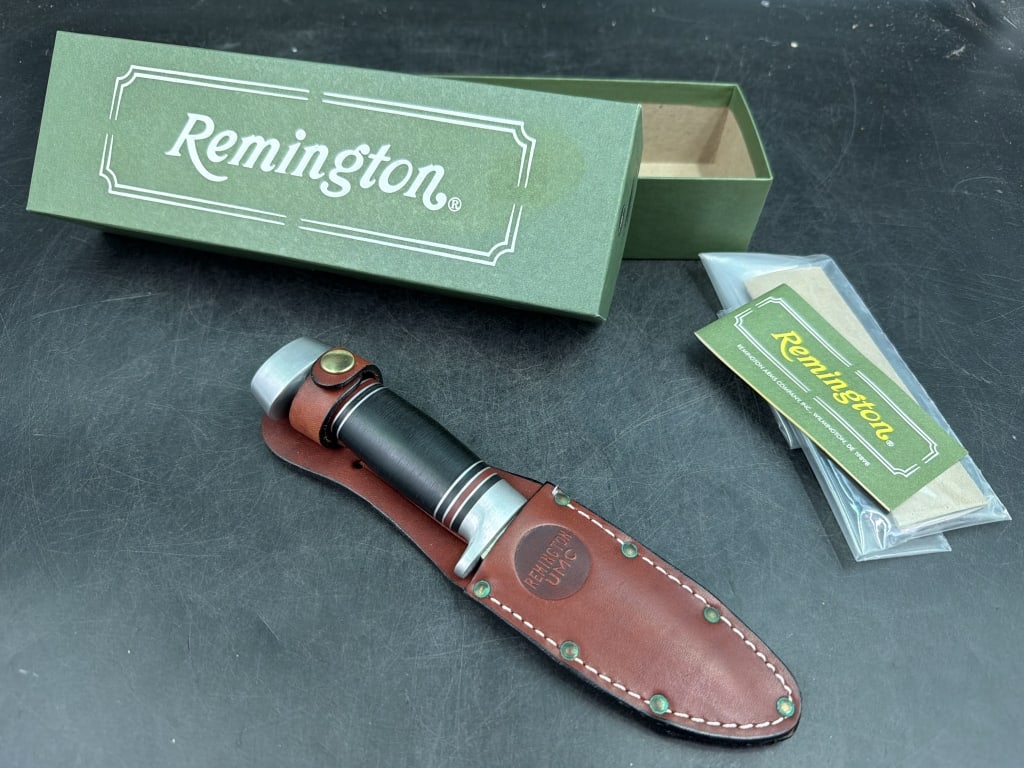Remington RH-134 Fixed Blade Hunting Knife: Comes with original green box and related paperwork.. Features a distinctive stacked black micarta handle and brown leather sheath. Condition is good, see pictures. No refunds given