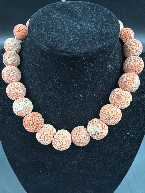 Sponge Coral Necklace: Natural sponge coral beaded necklace characterized by its distinctively porous, honeycomb like texture and light salmon pink coloration. Measures about 12" l. Graduated beads that slightly increase