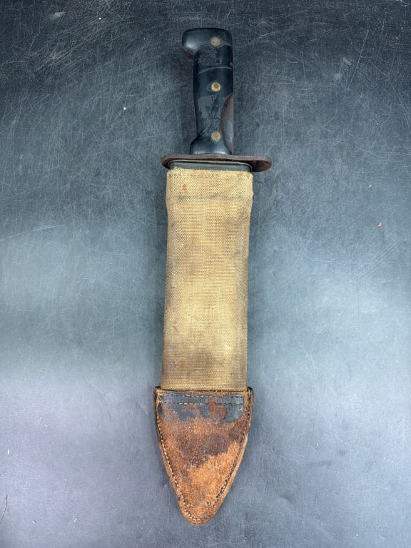 Vintage WWI Model 1917 Bolor Knife: Nice vintage knife that comes with scabbard featuring tan canvas and leather tipped bottom. Condition is consistent with age and use, see pictures. No refunds given.