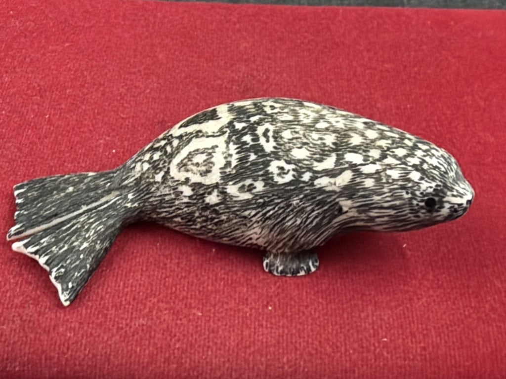 Alaskan Seal: Alaskan Artist is Lincoln Milligrock (deceased 2010) and dated 6/1/76. Detail in this piece is outstanding. Distinctive scrimshaw, see pictures. Measures 4" x 1.5". Condition is good, no refunds
