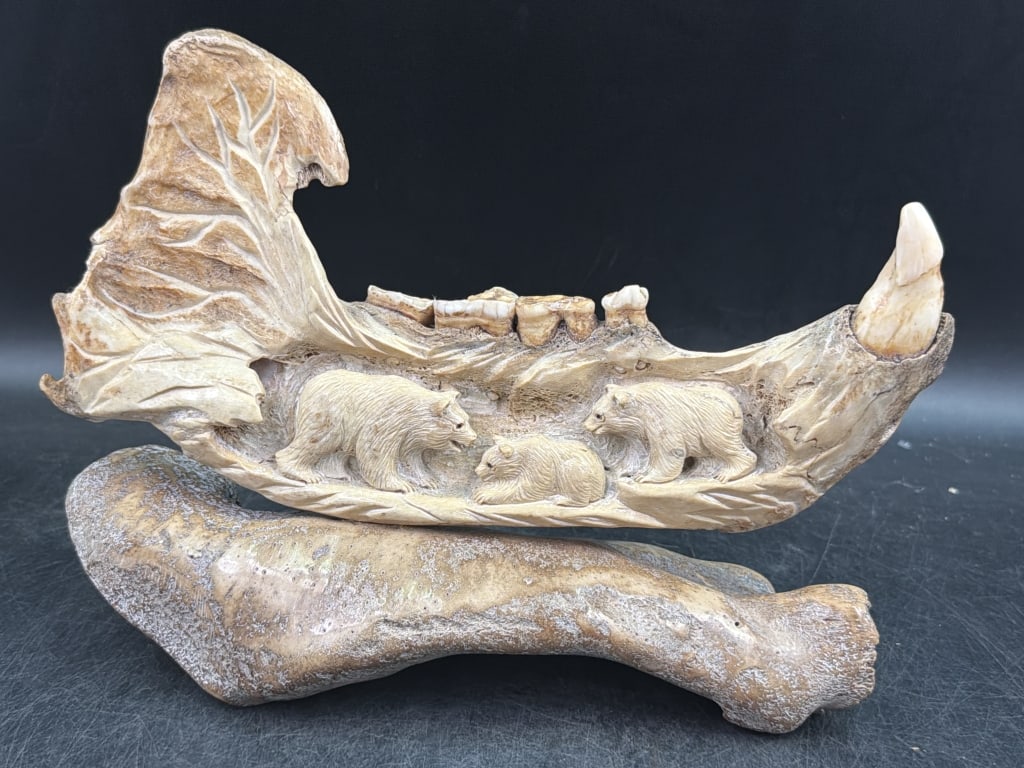 Eddie Lee Fossilized Jar Bone: Please see receipt for purchase in 2006. Signed by artist (Eddie Lee). Hand carved in the mandible and original molars and canine teeth completely intact. Depicts Ice Age wooly mammoths amidst a