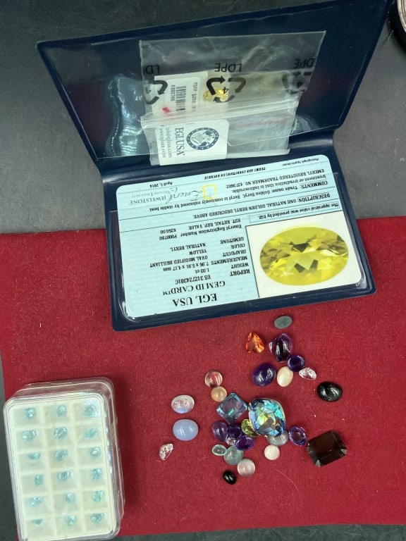Gemstones: Lot of gemstones, see pictures. There is amethyst, aqua marine. A multiple variety. See pictures, no refunds given.