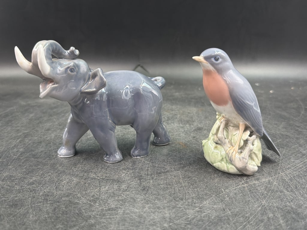 Vintage Royal Copenhagen Porcelain Figurines: One is "Robin" porcelain bird figurine measures 4" and has classic Danish underglaze painting with high gloss finish. The other is a elephant figurine. Features glossy grey glaze and a raised trunk. M