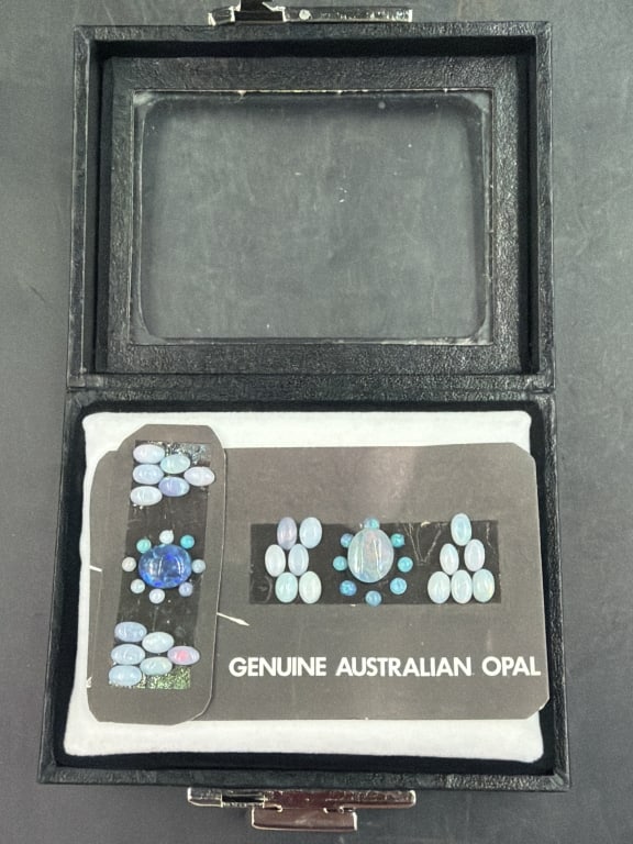 Genuine Australian Opals: Nice lot of opals arranged in black display card. Collection features various shapes including multiple oval cabochons and small round stones. See pictures, condition is good. No refunds given.