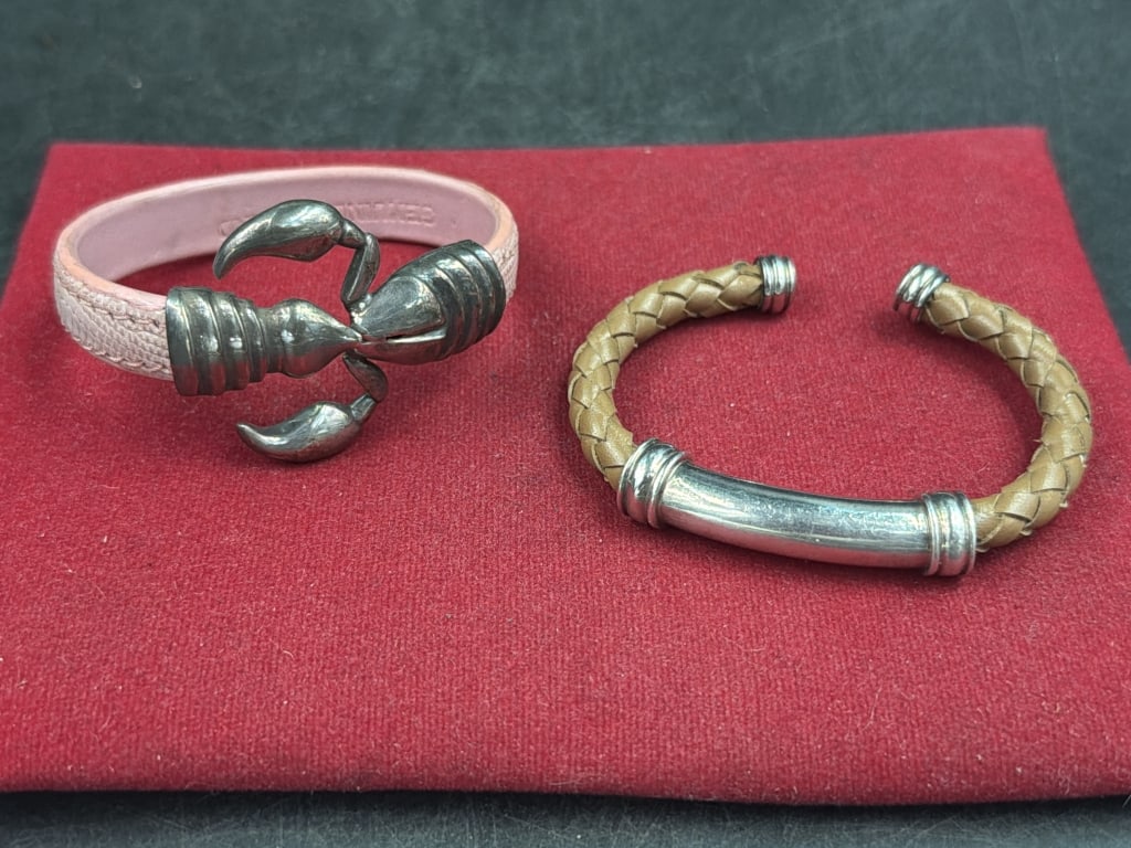 Sterling and Leather Cuff Bracelets: One has scorpion charm with pink leather bracelet and the other is braided brown leather bracelet with silver end caps and flat silver. Condition appears good, see pictures. No refunds given.